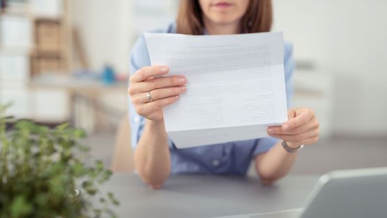 Frau liest einen Vertrag